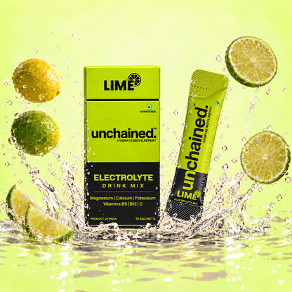 Unchained Lime Electrolyte Drink Mix 10-stick box and stick surrounded by fresh lime slices and water splash