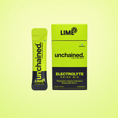 Unchained Lime electrolyte drink mix stick next to its 10-stick box on a lime green background