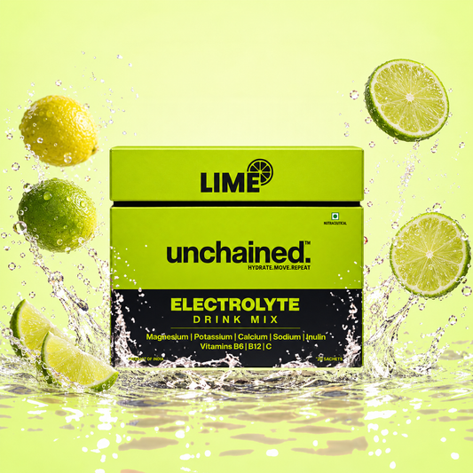 Unchained Lime Electrolyte Drink Mix 20-stick family pack box surrounded by fresh lime slices and water splash