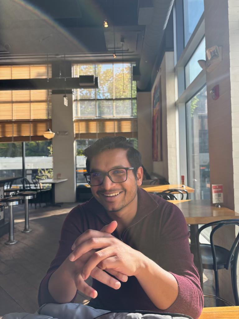 Man sitting at a table in a restaurant with large windows
