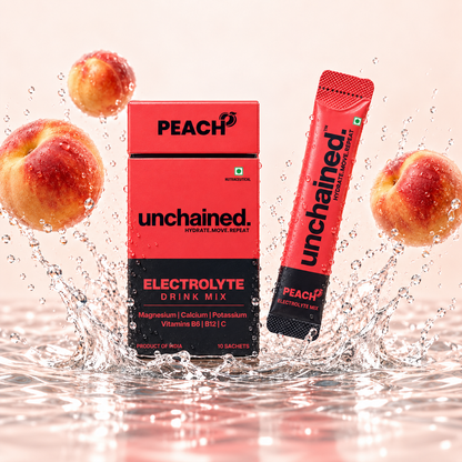 Unchained Peach Electrolyte Drink Mix 10-stick box and stick surrounded by fresh peaches and water splash