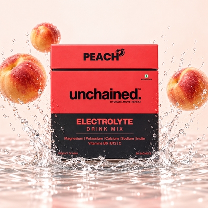 Unchained Peach Electrolyte Drink Mix box surrounded by fresh peaches and water splash